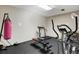 A shared workout space featuring a heavy punching bag, treadmill, elliptical machine, and weight-lifting bench at 4160 Fruitville Rd # 77, Sarasota, FL 34232