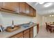 Kitchen area showcasing counter space with wine, white appliances, and easy access to the dining area at 4160 Fruitville Rd # 77, Sarasota, FL 34232