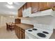 Practical kitchen showcasing white oven, microwave, and ample cabinet space, offering convenience for cooking and storage at 4160 Fruitville Rd # 77, Sarasota, FL 34232