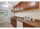 Efficient kitchen layout with ample cabinetry, a stainless steel sink, and a window, providing functionality and storage at 4160 Fruitville Rd # 77, Sarasota, FL 34232