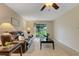 Living room features a brown leather sofa, ceiling fan, and sliding glass door with a view of the outdoors at 4160 Fruitville Rd # 77, Sarasota, FL 34232