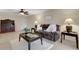 Open living room featuring a brown leather sofa, side tables, and ceiling fan at 4160 Fruitville Rd # 77, Sarasota, FL 34232