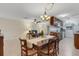 Open-concept living and dining area with tile floors, ceiling fan, and view to the kitchen and living room at 4160 Fruitville Rd # 77, Sarasota, FL 34232