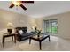 Living room features a brown leather sofa, ceiling fan, and sliding glass door with a view of the outdoors at 4160 Fruitville Rd # 77, Sarasota, FL 34232