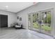 Community lobby with gray armchairs and view to outside through glass doors and fountain at 4160 Fruitville Rd # 77, Sarasota, FL 34232