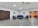 A community lounge area featuring comfortable seating, light gray flooring, and a view into a recreation room at 4160 Fruitville Rd # 77, Sarasota, FL 34232