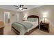 Bedroom with ensuite bathroom access featuring ceiling fan, side tables, and a peaceful, private space at 4160 Fruitville Rd # 77, Sarasota, FL 34232