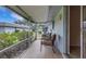 Enclosed patio with two cushioned chairs, neutral tiling, and view of manicured lawn and other residential buildings at 4160 Fruitville Rd # 77, Sarasota, FL 34232