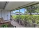 Enclosed patio with striped chair and view of manicured lawn and other residential buildings at 4160 Fruitville Rd # 77, Sarasota, FL 34232