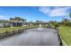 Scenic view of a tranquil pond with fountain, surrounded by well-maintained lawns and serene community homes at 4160 Fruitville Rd # 77, Sarasota, FL 34232