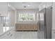 Bright kitchen showcasing white cabinets, stainless steel appliances, and stylish furnishings at 5107 W Platt St, Tampa, FL 33609