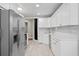 Well-lit kitchen features stainless steel appliances and white cabinets at 5107 W Platt St, Tampa, FL 33609