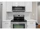 Clean kitchen with white cabinets, subway tile backsplash and stainless steel appliances at 5107 W Platt St, Tampa, FL 33609