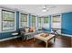 Bright living room with large windows, dark hardwood floors and colorful walls at 5107 W Platt St, Tampa, FL 33609