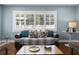 Cozy living room featuring hardwood floors, a plush sofa, and an abundance of natural light at 5107 W Platt St, Tampa, FL 33609