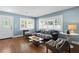 Living room with hardwood floors, natural light, and cozy seating at 5107 W Platt St, Tampa, FL 33609
