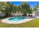 Backyard showcasing a large pool, palm trees, lounge chairs, and outdoor seating areas at 5107 W Platt St, Tampa, FL 33609