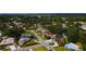 Aerial view of home and neighborhood with lush trees and a glimpse of the bay at 5501 Highland S St, St Petersburg, FL 33705