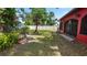Lush backyard garden with mature trees, a privacy fence, and vibrant landscaping at 5501 Highland S St, St Petersburg, FL 33705