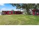 Spacious backyard featuring a well-manicured lawn, mature trees, and a cozy gazebo at 5501 Highland S St, St Petersburg, FL 33705