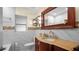 Elegant bathroom featuring a granite countertop, decorative mirror, and stylish fixtures at 5501 Highland S St, St Petersburg, FL 33705