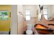 Charming bathroom with colorful vessel sink, tiled walls, and natural light from the window enhancing its appeal at 5501 Highland S St, St Petersburg, FL 33705