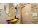 Modern bathroom with an artistic vessel sink, unique stone wall, and a shower featuring a multi-jet system at 5501 Highland S St, St Petersburg, FL 33705