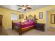 Sunny bedroom with a decorative metal bed frame, wood floors, and bright yellow walls at 5501 Highland S St, St Petersburg, FL 33705