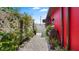 Exterior side view showing a walkway lined with decorative rock and lush garden space at 5501 Highland S St, St Petersburg, FL 33705