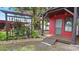View of a small red outbuilding with a deck and decorative landscaping at 5501 Highland S St, St Petersburg, FL 33705