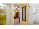 Hallway view revealing a home office with built-in bookshelves, a bathroom, and a glimpse of the home's layout at 5501 Highland S St, St Petersburg, FL 33705