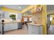 Modern kitchen with white cabinetry, stainless steel appliances, butcher block countertops and laminate flooring at 5501 Highland S St, St Petersburg, FL 33705