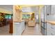 Modern kitchen featuring white cabinets, butcher block countertops and stainless steel appliances, seamlessly connecting to the living room at 5501 Highland S St, St Petersburg, FL 33705