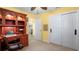 Spacious home office featuring built-in shelving, a work desk, and an adjacent closet for convenient storage at 5501 Highland S St, St Petersburg, FL 33705