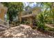 Spacious brick-paved backyard featuring potted plants, a white staircase, and outdoor seating at 635 Bay Ne St, St Petersburg, FL 33701