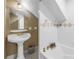 Elegant bathroom featuring a pedestal sink and a tiled bathtub with a glass shower door for a clean, classic look at 635 Bay Ne St, St Petersburg, FL 33701