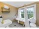 Bright bathroom showcasing a vintage clawfoot tub, white fixtures, and a window view bringing in natural light at 635 Bay Ne St, St Petersburg, FL 33701
