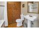 Bathroom featuring a sink, toilet, and a tub with a shower; note the orange floral wallpaper at 635 Bay Ne St, St Petersburg, FL 33701