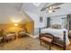 Cozy bedroom with a sloped ceiling, offering comfortable seating and a classic wooden bed beneath a ceiling fan at 635 Bay Ne St, St Petersburg, FL 33701