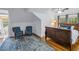 Charming bedroom featuring a sleigh bed, hardwood floors, vaulted ceilings, and two plush armchairs near bright windows at 635 Bay Ne St, St Petersburg, FL 33701