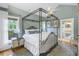 Spacious bedroom with a four-poster bed, ceiling fan, and ensuite bathroom at 635 Bay Ne St, St Petersburg, FL 33701
