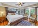 Spacious bedroom with hardwood floors, a king-size bed, and bright, natural light from several large windows at 635 Bay Ne St, St Petersburg, FL 33701