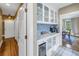 Charming butler's pantry featuring tile backsplash and glass-front cabinets at 635 Bay Ne St, St Petersburg, FL 33701