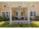 Inviting front porch with white pillars, decorative railing, and clear view of the house number at 635 Bay Ne St, St Petersburg, FL 33701