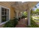 Charming front porch with tiled floor, potted plants, and decorative white pillars and railings at 635 Bay Ne St, St Petersburg, FL 33701