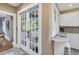 Eat-in kitchen has white cabinets and bar seating; French doors lead to the porch at 635 Bay Ne St, St Petersburg, FL 33701