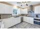 Bright kitchen with stainless steel appliances, white cabinets and neutral backsplash at 635 Bay Ne St, St Petersburg, FL 33701
