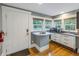 Kitchenette featuring white cabinets, hardwood floors, and a small bar area at 635 Bay Ne St, St Petersburg, FL 33701