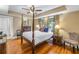 Spacious main bedroom with hardwood floors, four-poster bed, and plenty of natural light at 635 Bay Ne St, St Petersburg, FL 33701