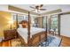 Spacious main bedroom with hardwood floors, four-poster bed, tray ceiling, and natural light at 635 Bay Ne St, St Petersburg, FL 33701